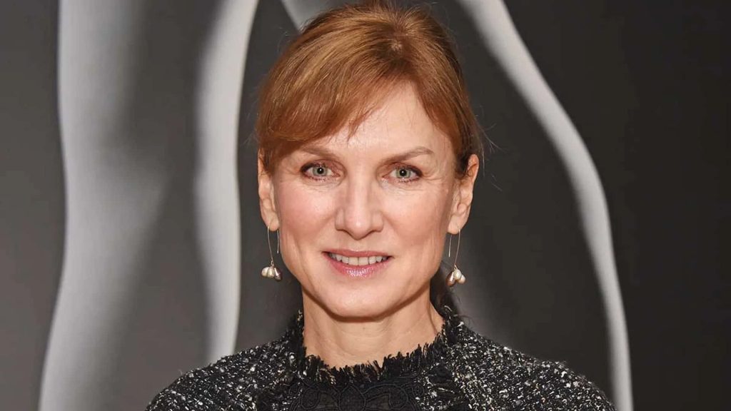 Fiona Bruce professional portrait with auburn hair black top and silver earrings on abstract background Wallpaper