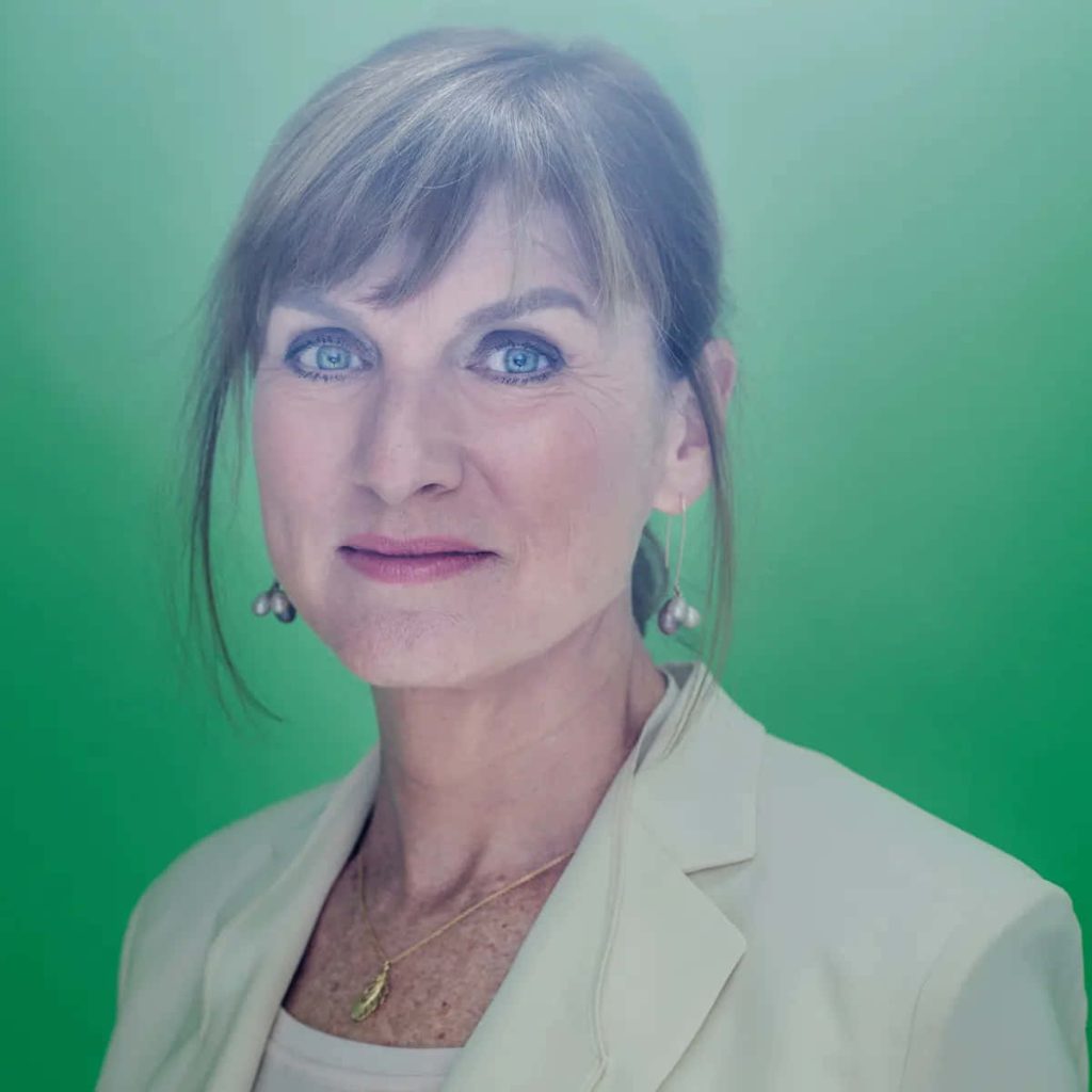 Professional headshot of British journalist Fiona Bruce in cream blazer with green screen background Wallpaper