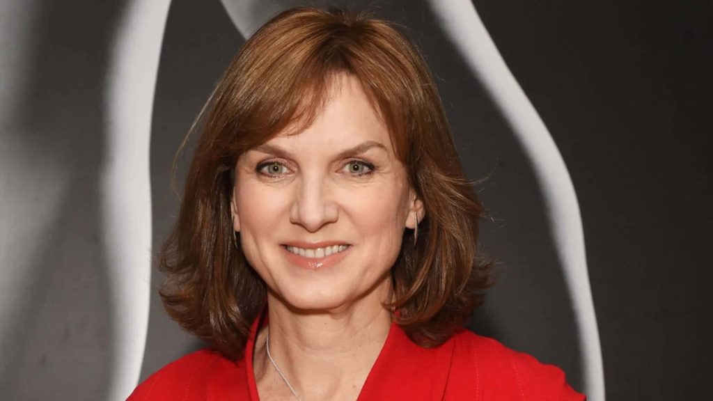 Fiona Bruce smiling in red top studio portrait dark background white curves auburn hair lighting Wallpaper