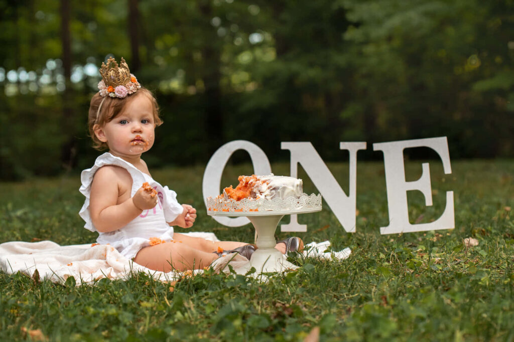 Adorable Baby in Floral Crown: First Birthday Cake Smash in Nature Wallpaper