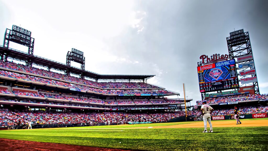 Vibrant packed baseball game at First Energy Stadium Cleveland with dramatic skies and green field Wallpaper