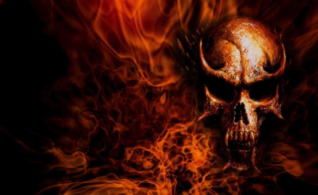 Menacing horned demonic skull engulfed in swirling orange flames on black fiery wallpaper background