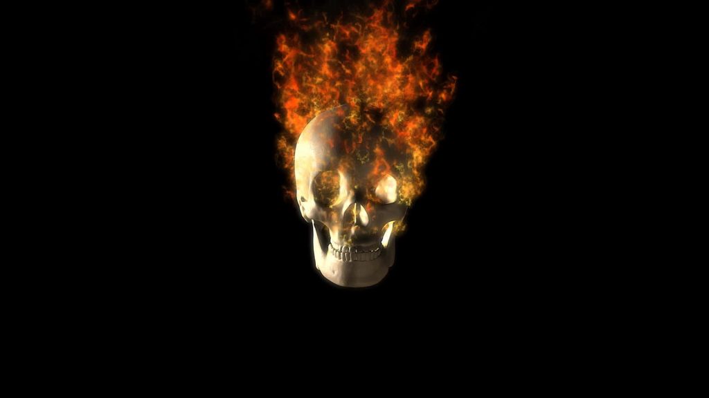 Hyper-realistic 3D flaming skull wallpaper with intense orange fire on black background