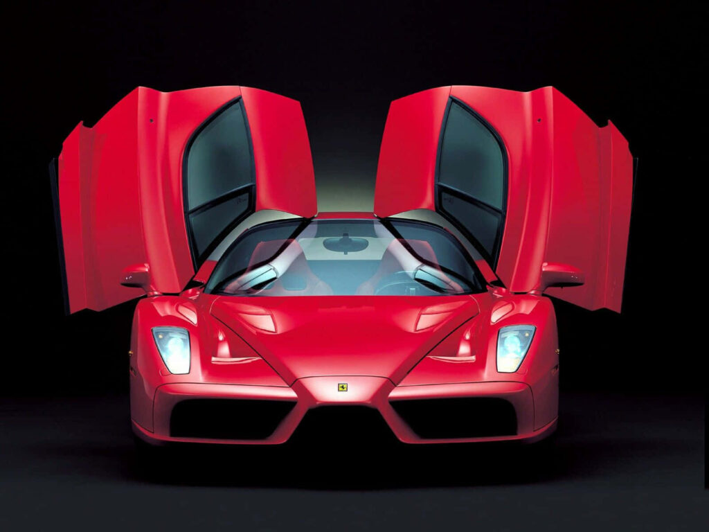 Capturing the Thrilling Elegance and Powerful Performance of the Ferrari Enzo on the Open Road: A Breathtaking Snapshot Wallpaper