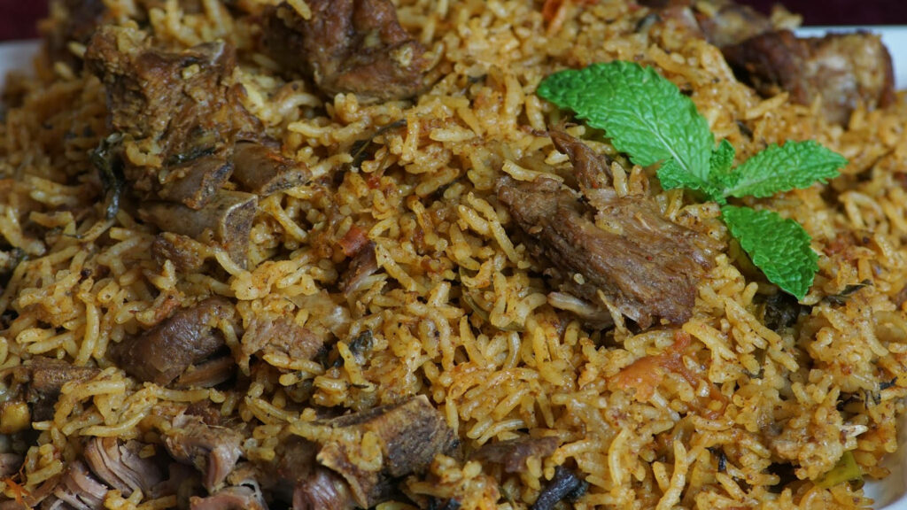 Close-up of tender beef biryani with spiced rice and fresh mint leaves wallpaper background