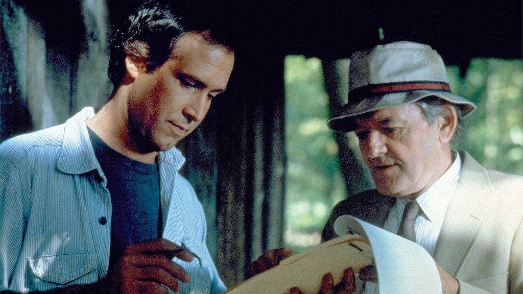 Fletch Lives 1989 Chevy Chase Hal Holbrook rustic scene studying documents retro wallpaper