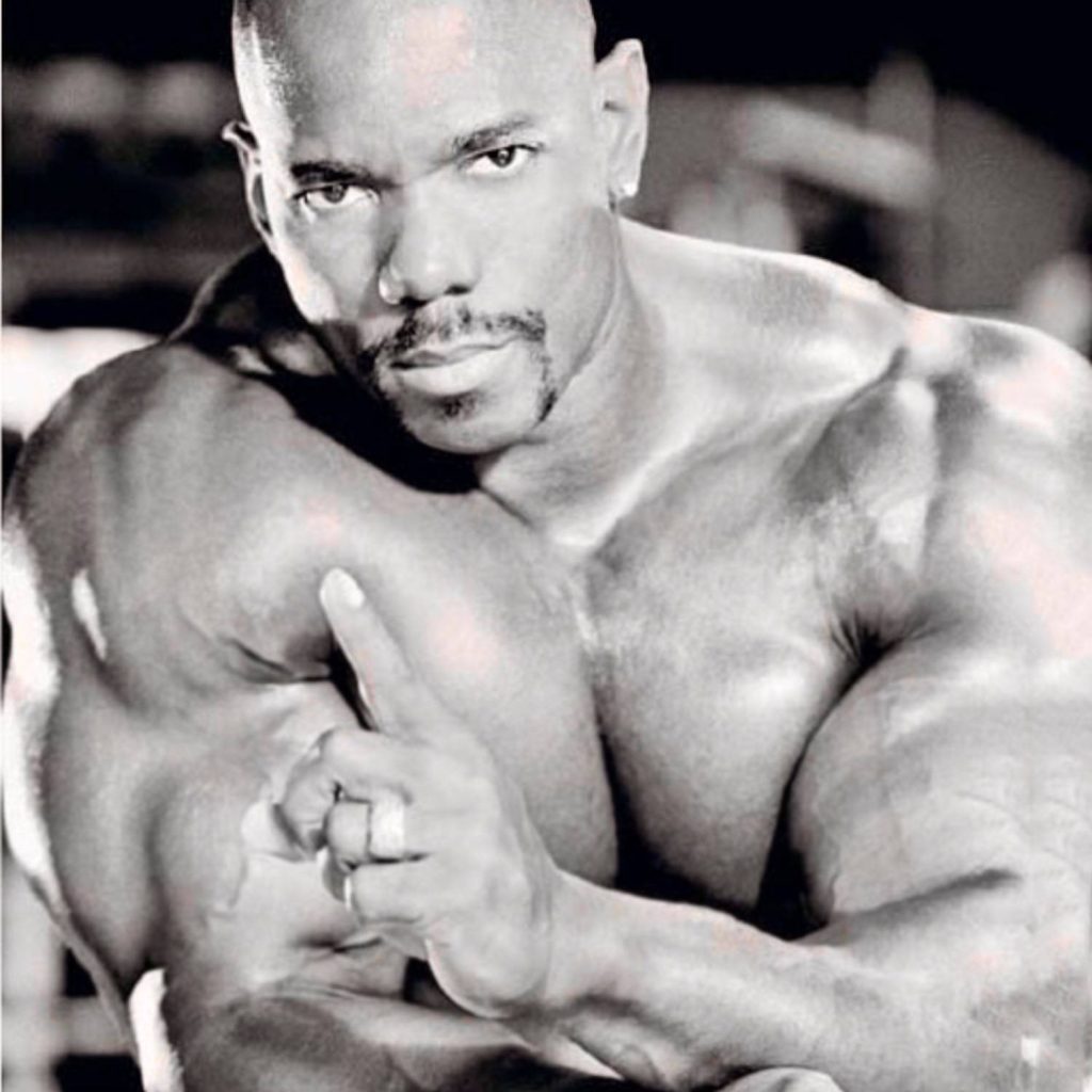 Black and white portrait of IFBB pro Flex Wheeler showcasing muscular physique and focus Wallpaper