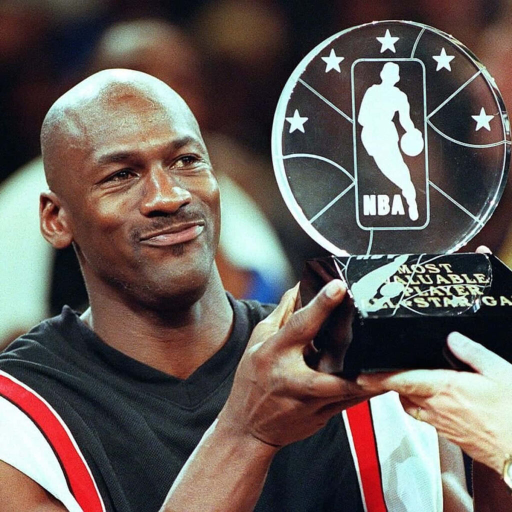 Flying with Resolve and Passion: Michael Jordan's Timeless Emblem of Basketball Dedication Wallpaper
