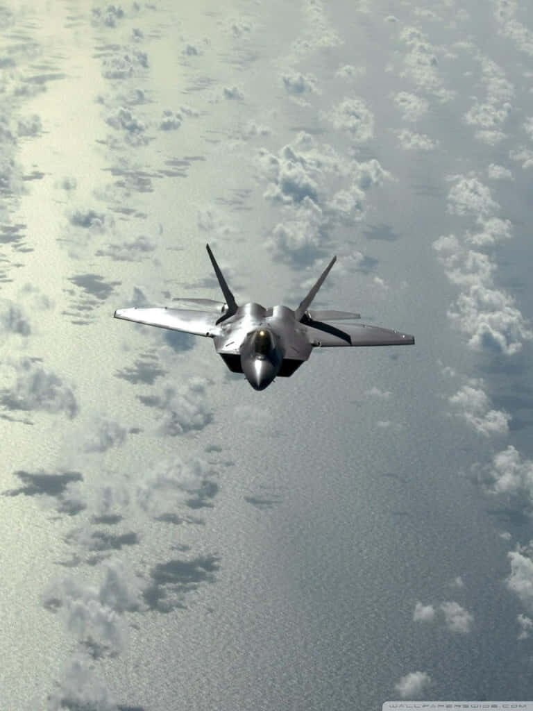 Skies of Supremacy: Capturing the Majestic F-22 Raptor in Flight Wallpaper