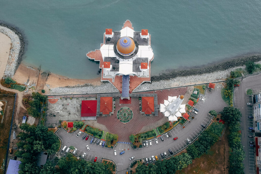 Aerial View of a Breathtaking Floating Mosque, Demonstrating Islamic Splendor Wallpaper
