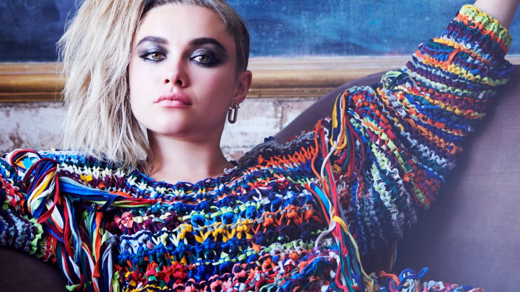 Florence Pugh in vibrant crochet sweater smoky makeup intense gaze moody dark background portrait Wallpaper
