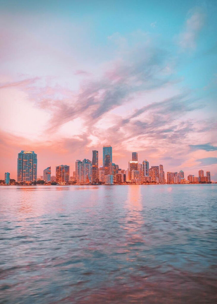 Florida Candy Skies wallpaper with pastel pink blue skies over calm waterfront cityscape background