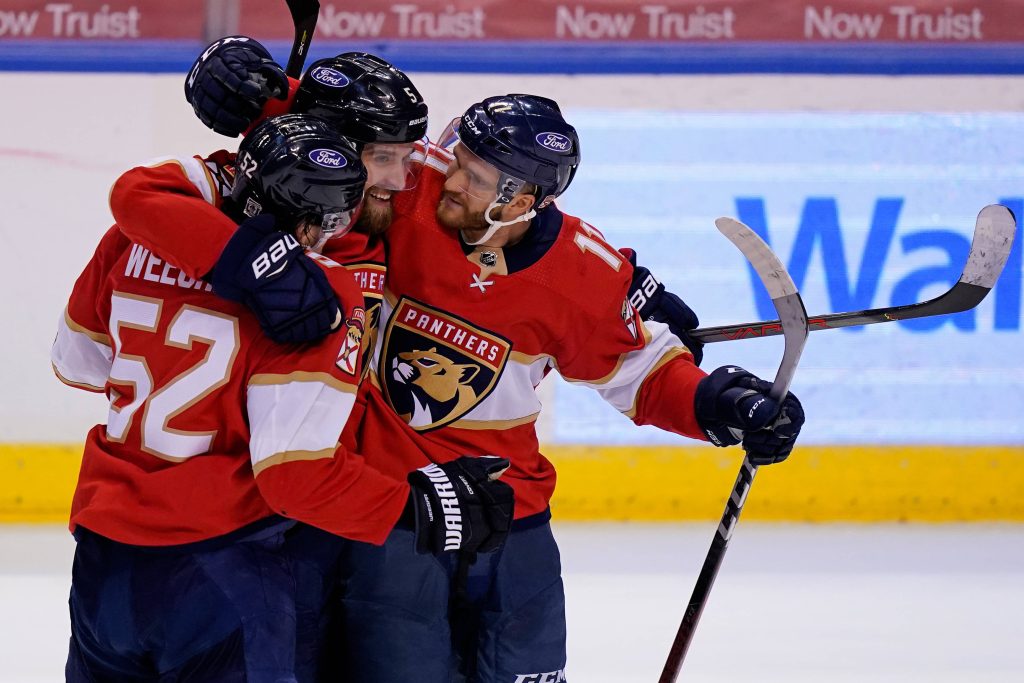 Florida Panthers goal celebration with Ekblad Weegar Marchment in red jerseys NHL wallpaper