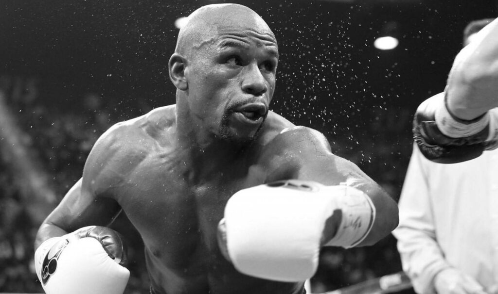 Floyd Mayweather Black-and-White Wallpaper: Powerful Punch Action