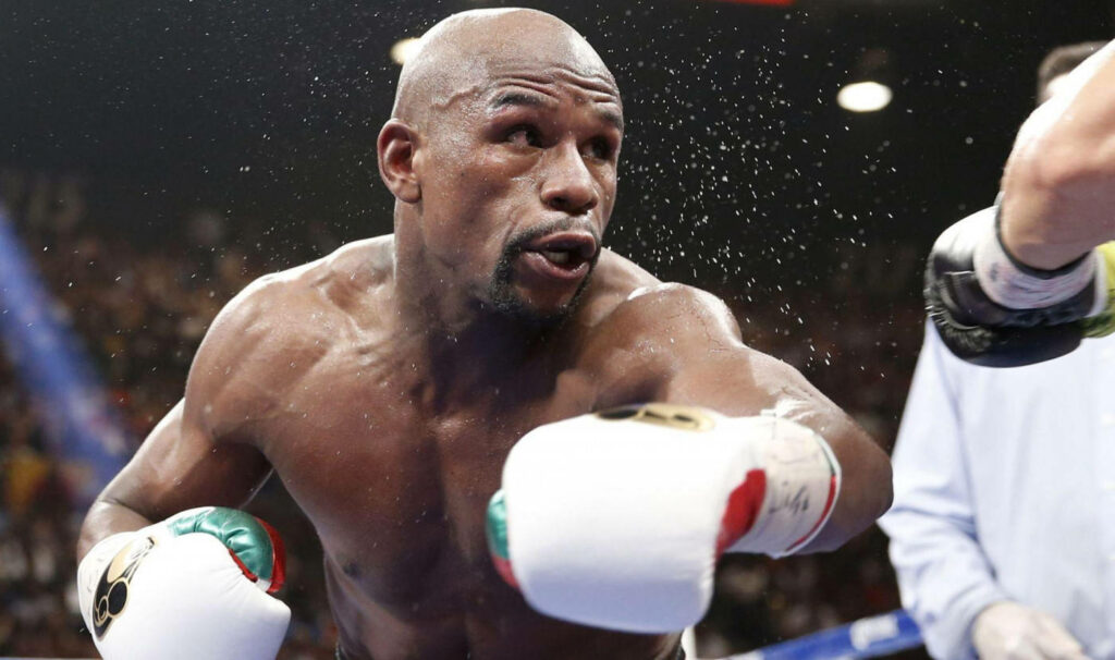 Floyd Mayweather Action Wallpaper: Intense Boxing Punch Background