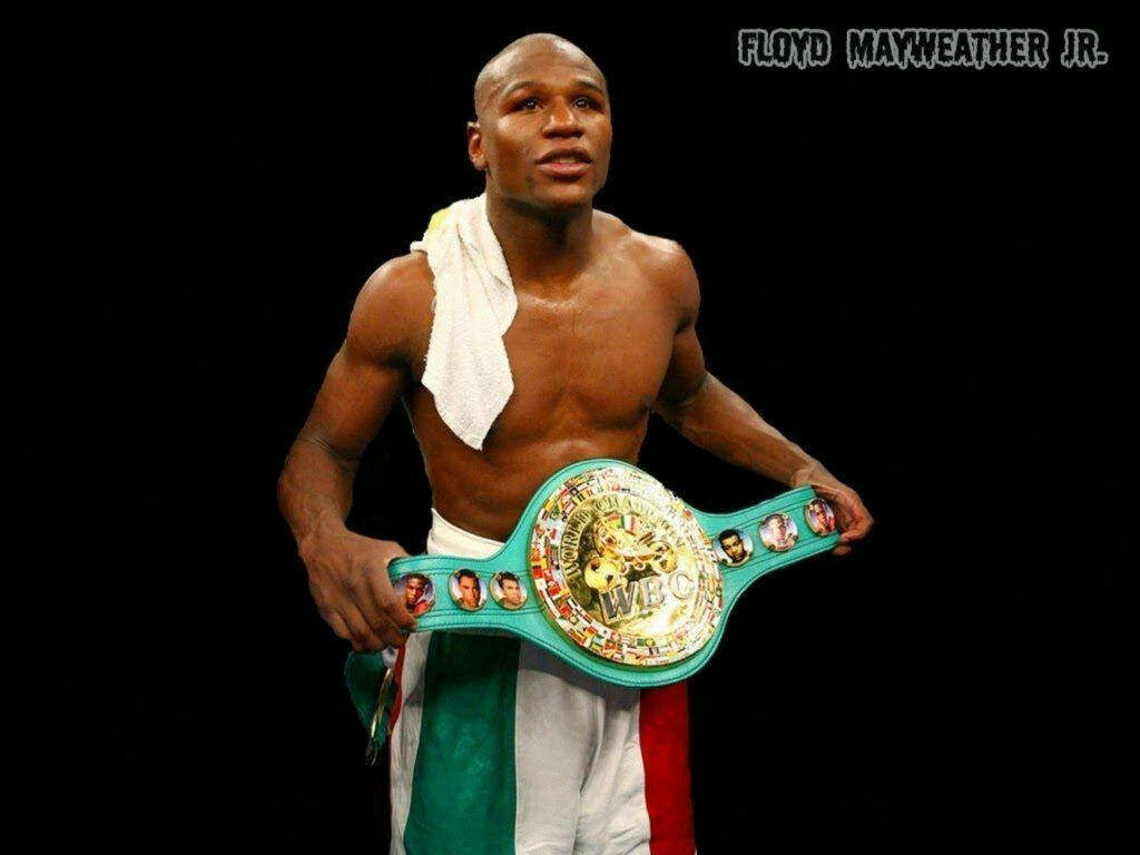Floyd Mayweather with Championship Belt - Confident Boxing Triumph Wallpaper