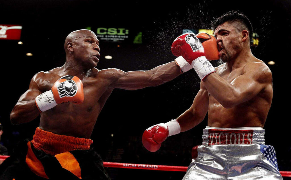 Floyd Mayweather Punch Wallpaper: Intense Boxing Match Background
