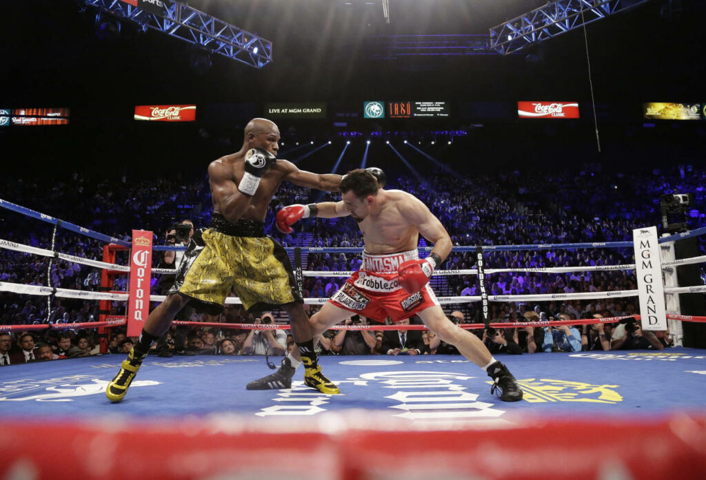 Floyd Mayweather Mid-Punch: Dynamic Boxing Match Wallpaper