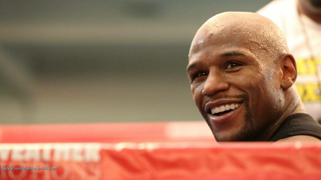 Floyd Mayweather: Confident Smile in Boxing Ring – Energetic Wallpaper