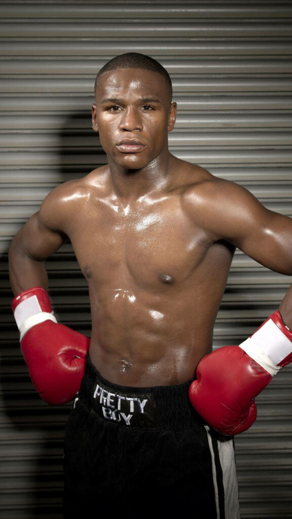 Floyd Mayweather: Confident Boxing Icon Wallpaper with Red Gloves