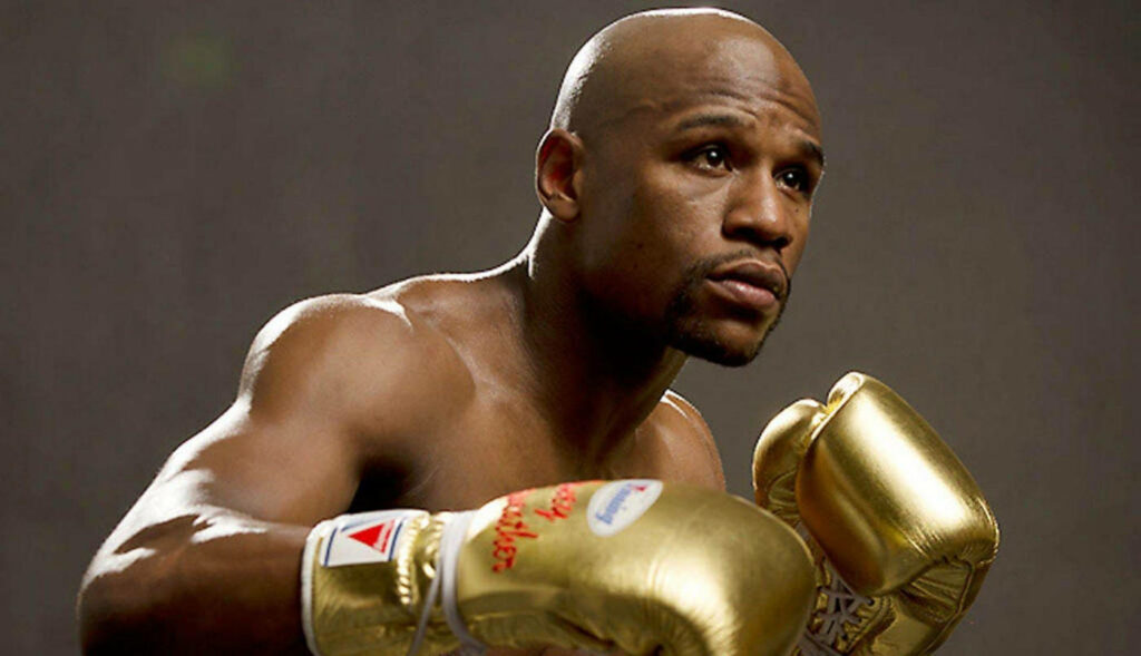 Floyd Mayweather Wallpaper: Iconic Pose in Golden Boxing Gloves