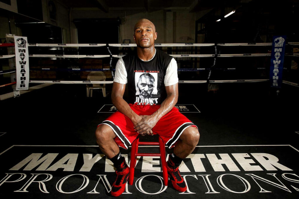Floyd Mayweather in Gym: Boxing Icon on Red Chair Wallpaper