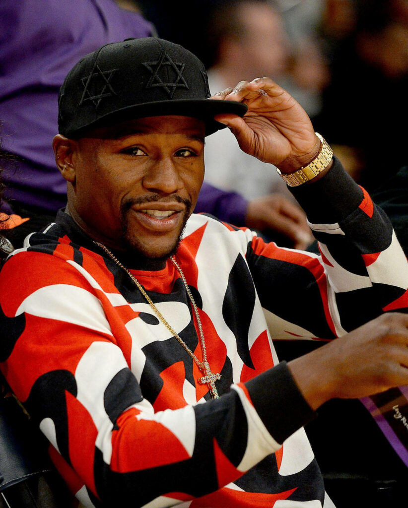 Floyd Mayweather in Stylish Outfit with Cap and Gold Watch Wallpaper