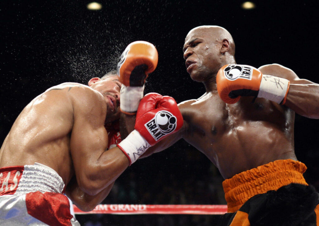 “Floyd Mayweather's Powerful Hook: Intense Boxing Match Wallpaper”