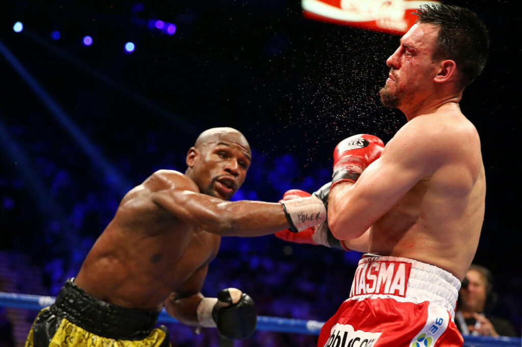 Floyd Mayweather's Powerful Punch - Intense Boxing Match Wallpaper