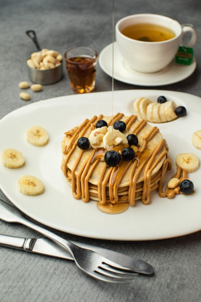 Fluffy Pancakes with Syrup, Peanut Butter, Bananas & Blueberries Wallpaper