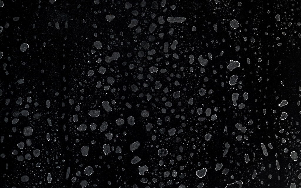 Black textured wallpaper with irregular white splatters for modern minimalist desktop background