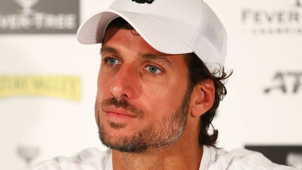 Close-up portrait of tennis star Feliciano López in white cap with focused intense gaze wallpaper
