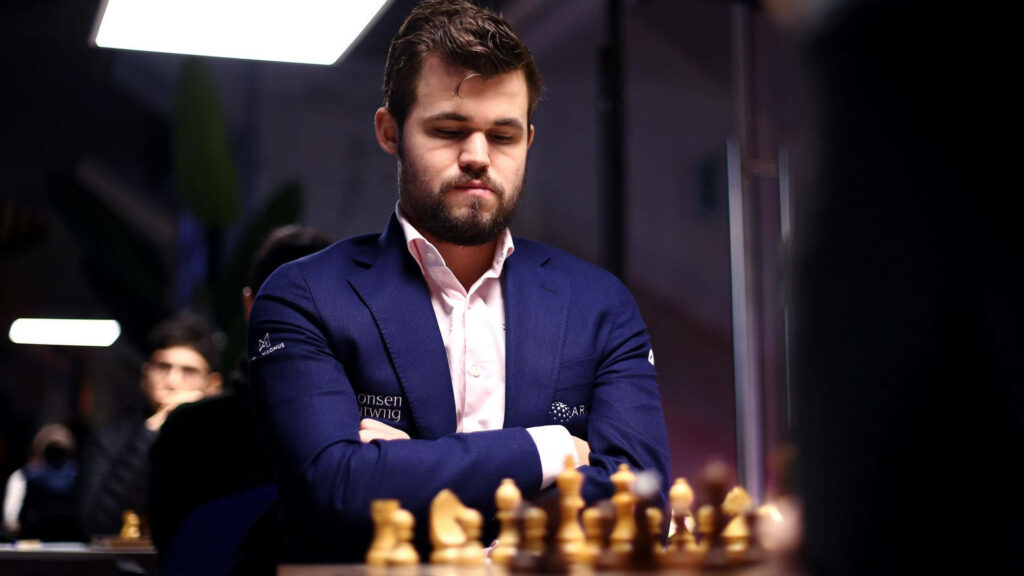 Magnus Carlsen: Concentrated Chess Champion Wallpaper Background