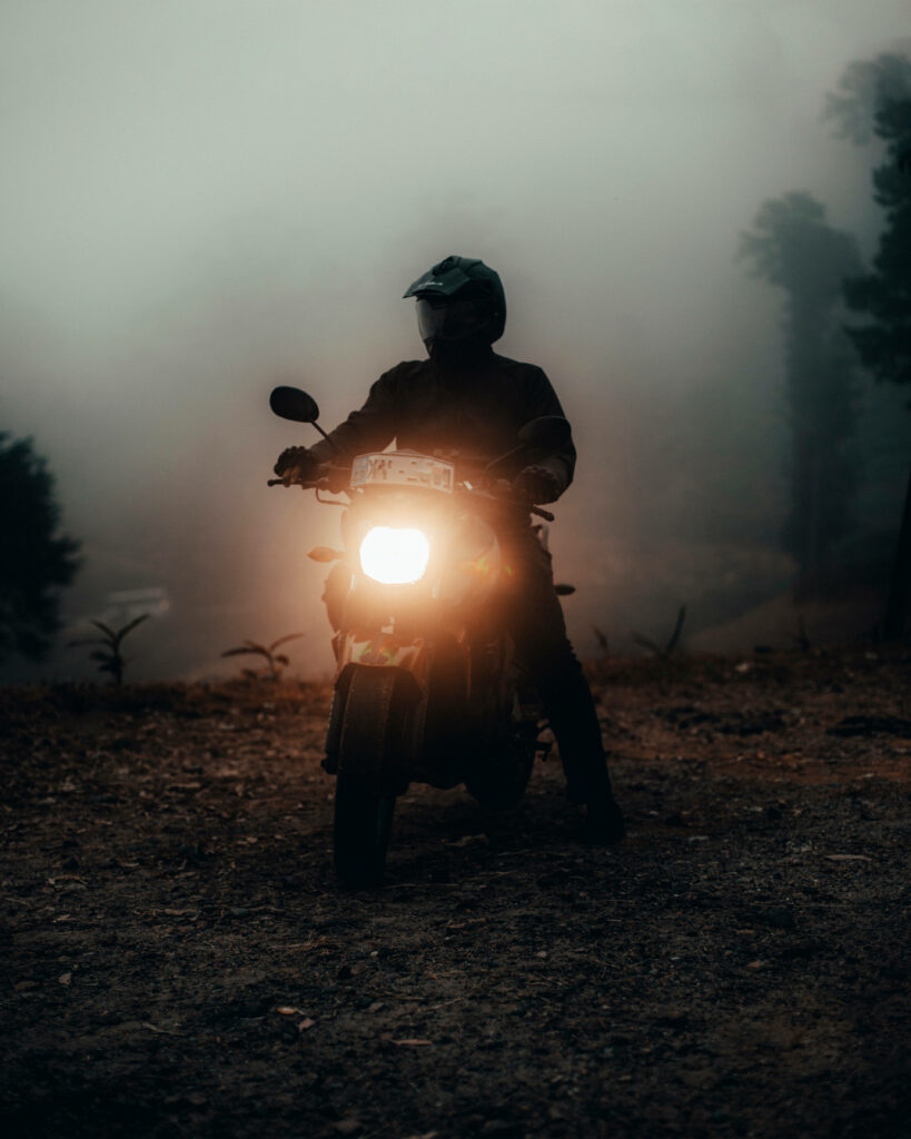 Misty Adventure: A Bike Enthusiast Embracing the Fog on His Motorcycle Ride Wallpaper