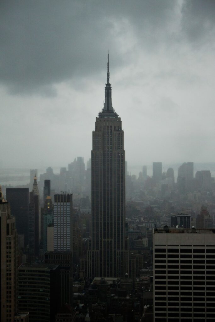 Foggy Skyline Wallpaper: Dramatic Aerial View of a Towering Skyscraper