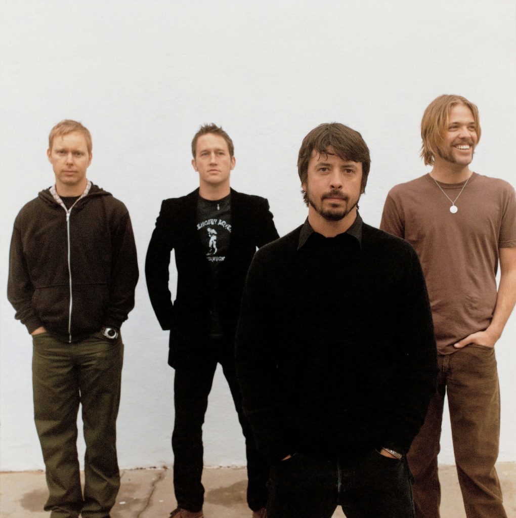 Foo Fighters band portrait with Dave Grohl Nate Mendel Chris Shiflett Taylor Hawkins on white background Wallpaper