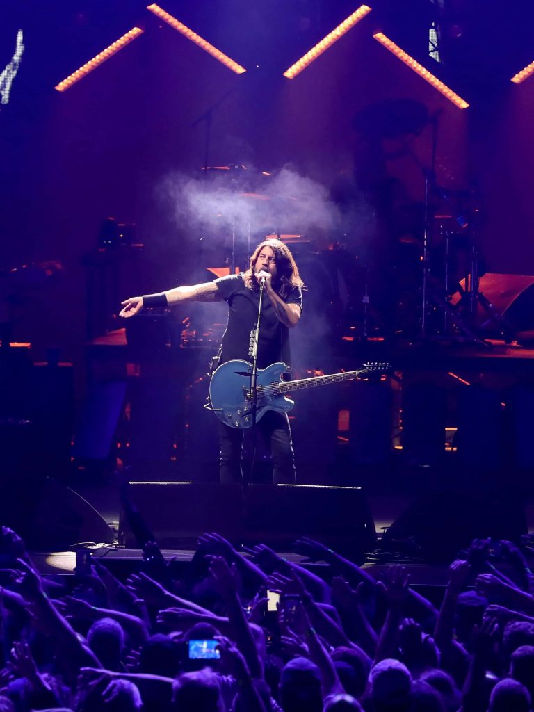 Dave Grohl Foo Fighters live concert purple lighting blue guitar high energy rock wallpaper background