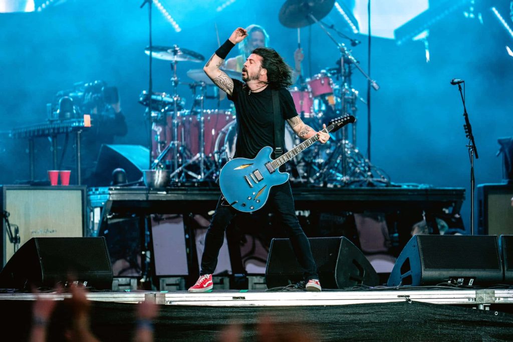 Foo Fighters live concert with Dave Grohl blue guitar and Taylor Hawkins drums blue stage lighting Wallpaper