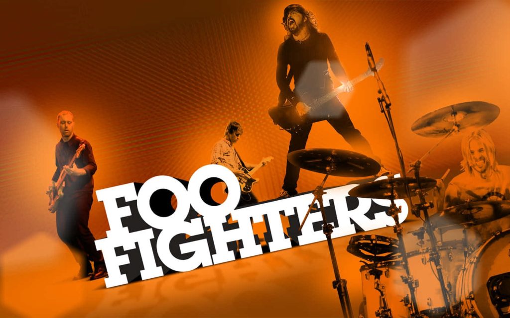 Foo Fighters live performance wallpaper with Dave Grohl Taylor Hawkins vibrant orange background
