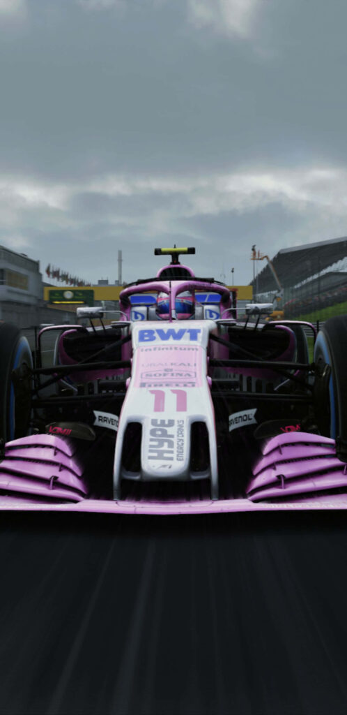 Front view of Force India F1 2018 race car with pink white livery on high-speed track wallpaper