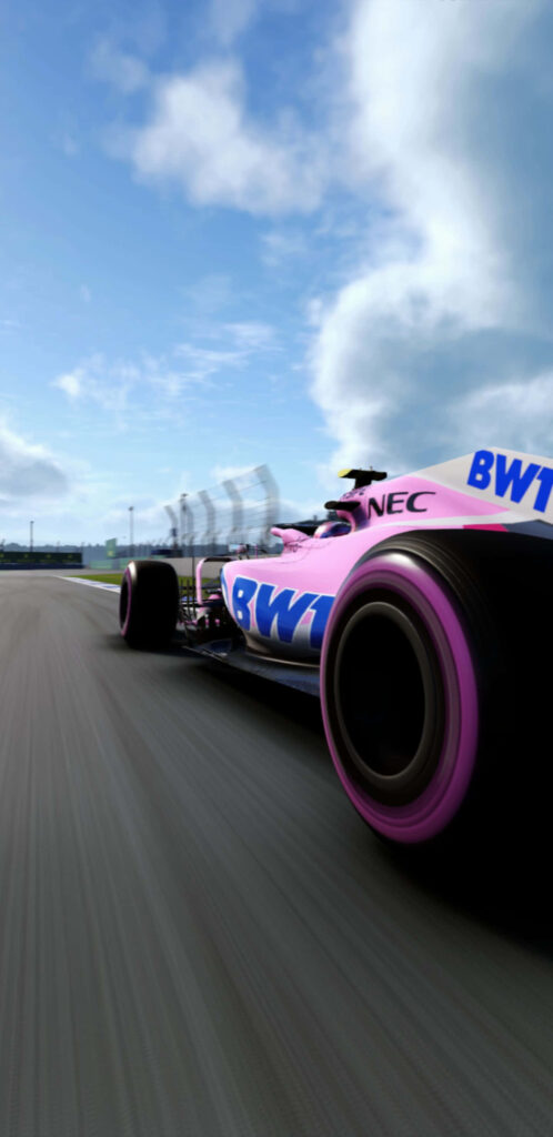 Force India VJM11 2018 F1 car with pink blue BWT livery racing on track under cloudy sky wallpaper