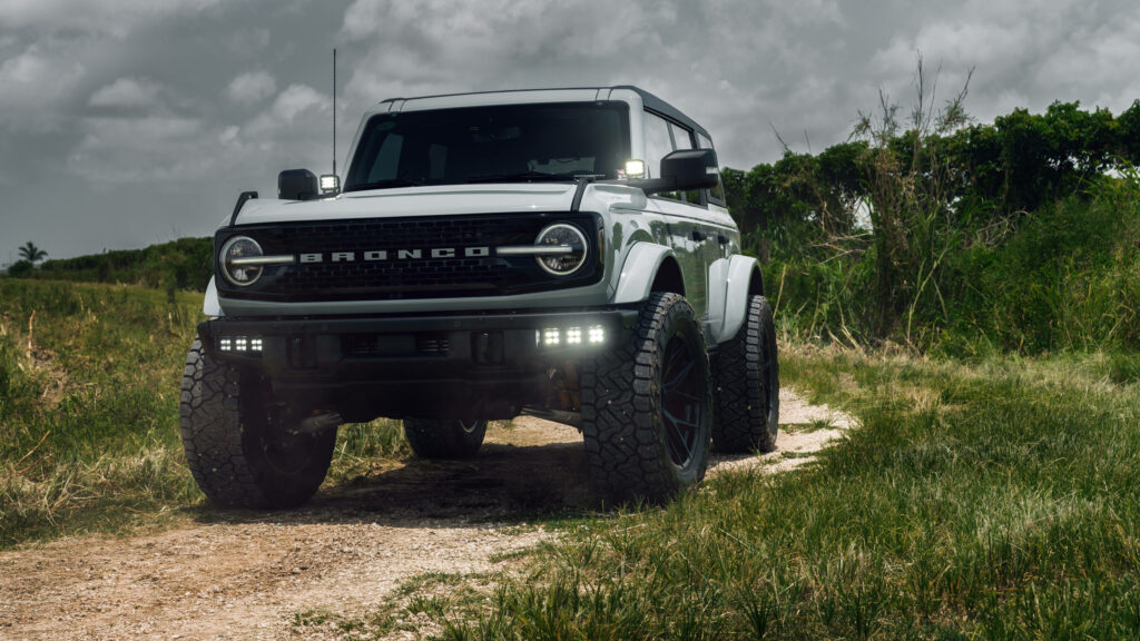 Ford Bronco rugged SUV on scenic off-road trail 4K wallpaper background adventure vehicle