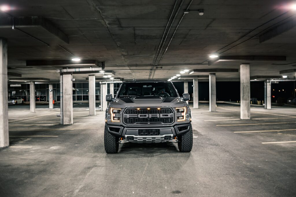 Ford F-150 Showcase: Rugged Design in Dimly Lit Garage Wallpaper