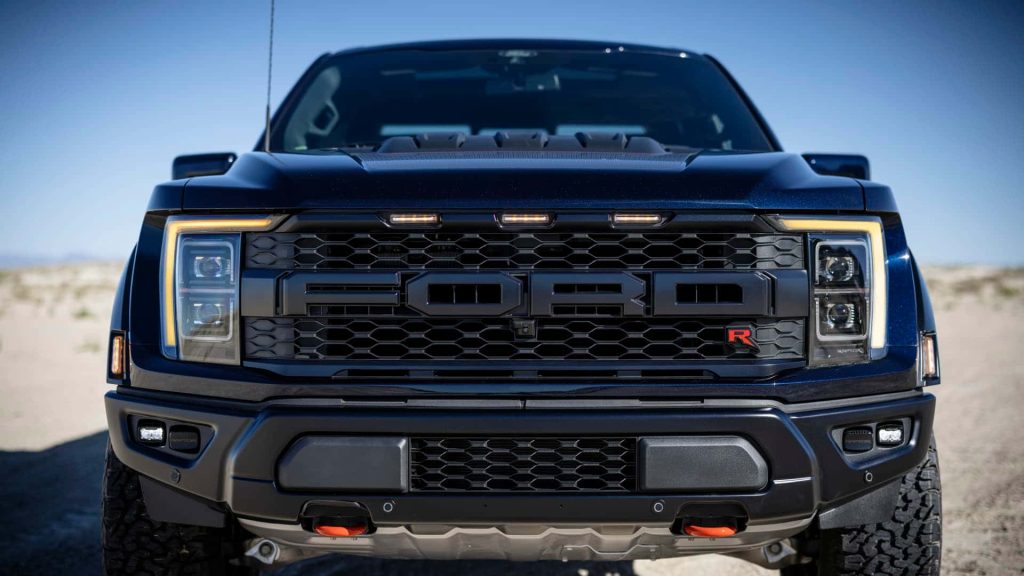 Ford F-150 Raptor R front view with amber lights and red R badge in desert background wallpaper