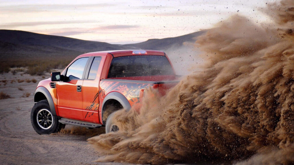 Ford F-150 rugged truck kicking up sand showcasing power durability and adventure wallpaper