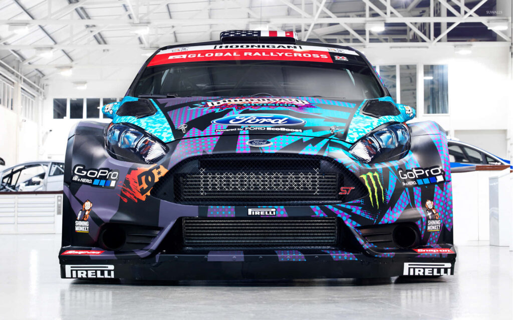 Ford Fiesta rally car with vibrant decals and sponsor logos in sleek modern garage background Wallpaper