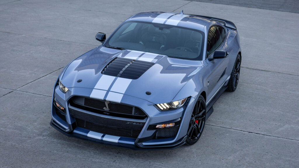 Ford Mustang blue wallpaper with white racing stripes aggressive sporty design concrete background