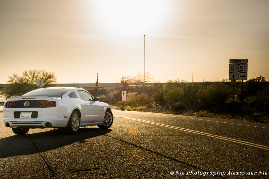 Ford Mustang Sunset Wallpaper: Freedom and Adventure on Asphalt