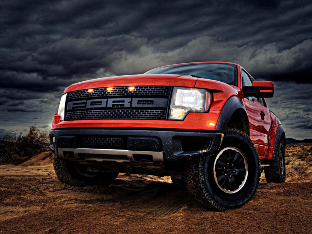 Ford Ranger off-road truck on rugged terrain with dramatic cloudy sky background wallpaper