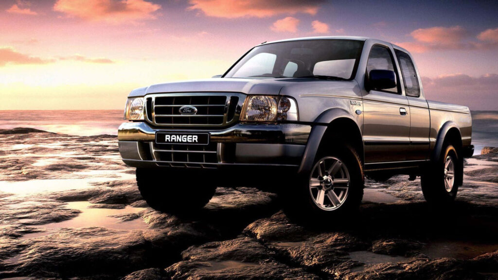 Ford Ranger on rocky terrain at sunset showcasing rugged strength and adventure design wallpaper